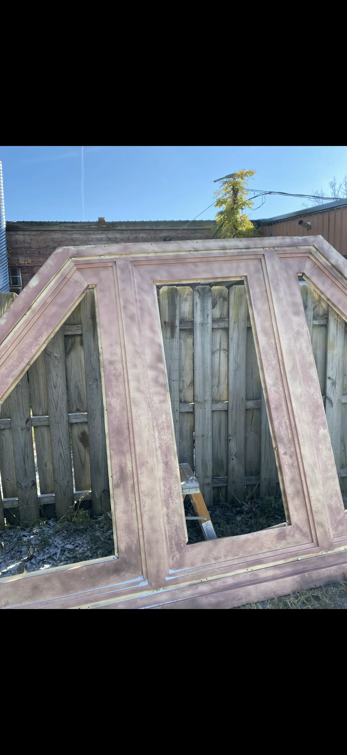 Sandblasted steel frame structure with angled supports and window openings, rust removed