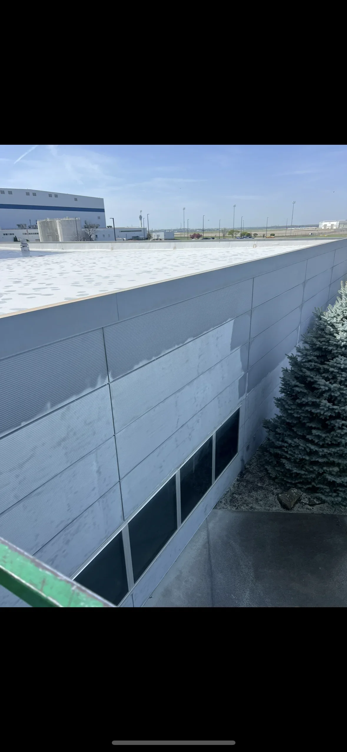 Sandblasted corrugated metal walls and flat roof on industrial commercial building