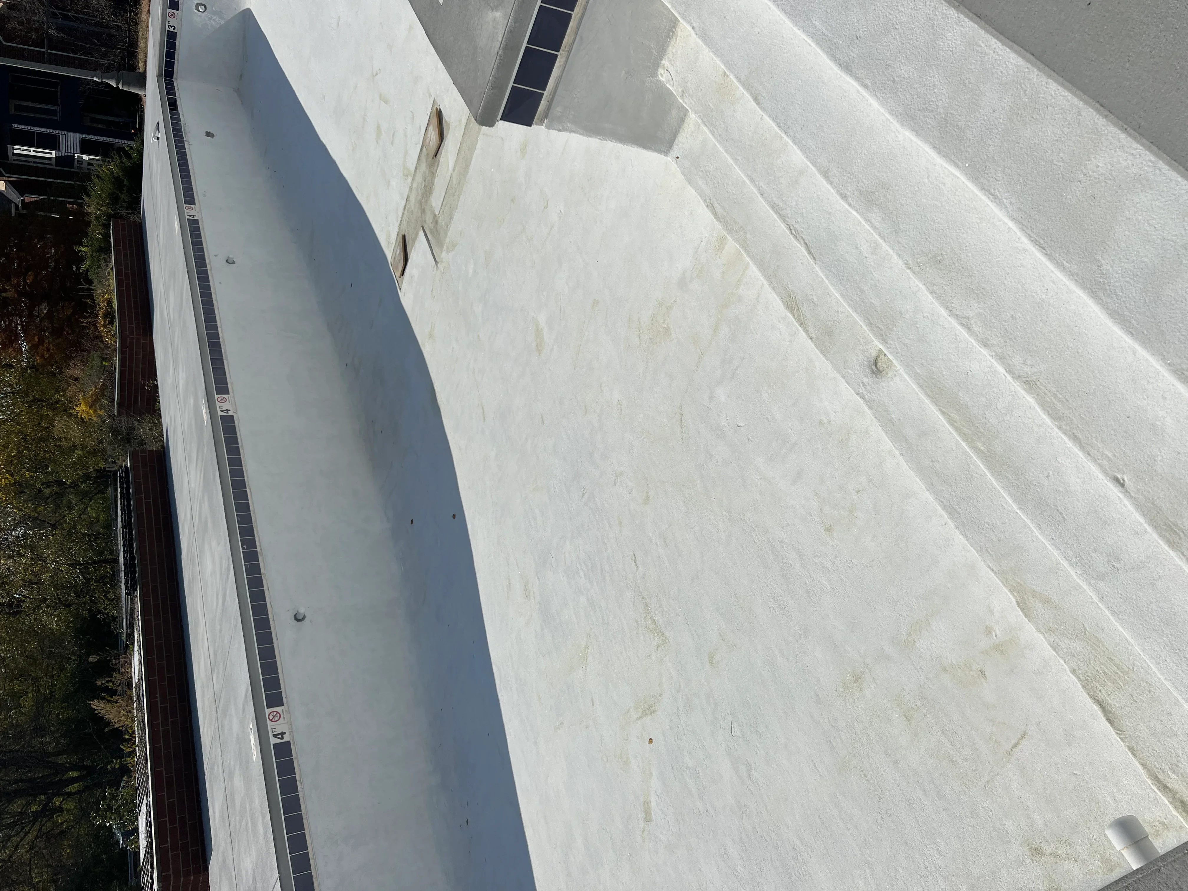 Clean concrete driveway after sandblasting, showing uniform surface preparation and debris removal