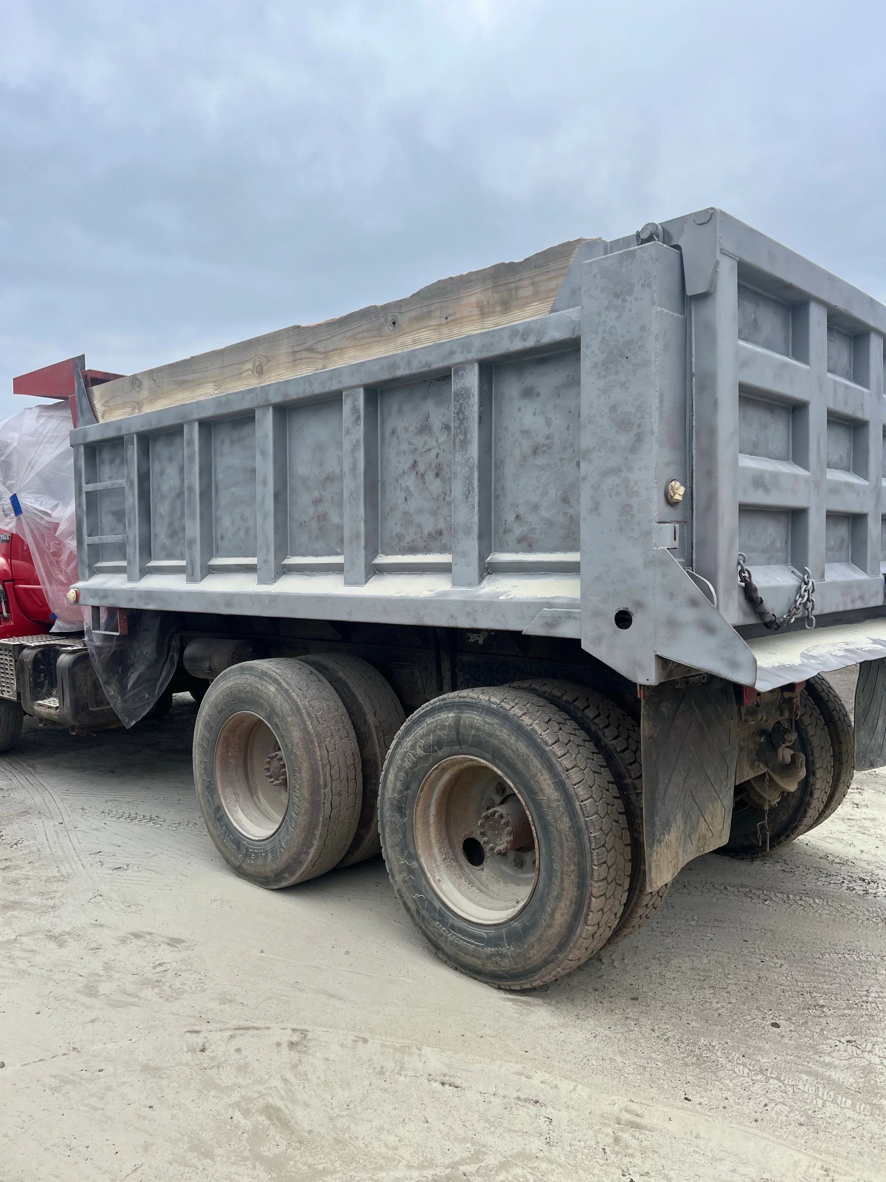 Sandblasted dump truck bed with exposed steel hopper box and structural ribs