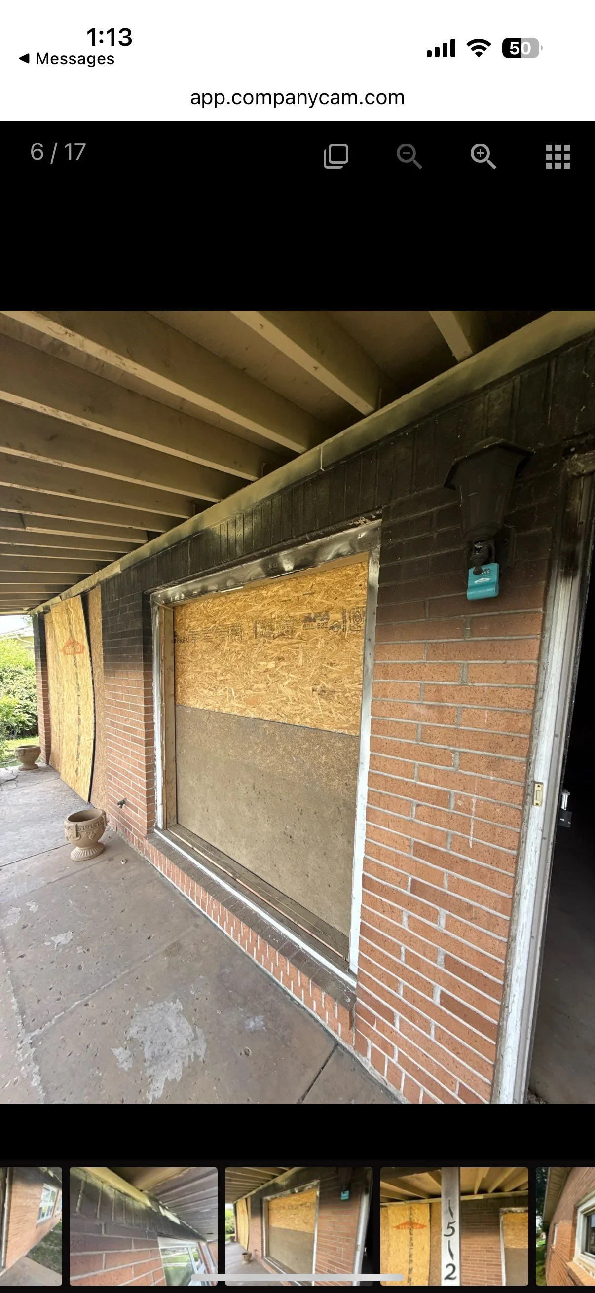 Sandblasted red brick wall and steel beam framework under covered structure