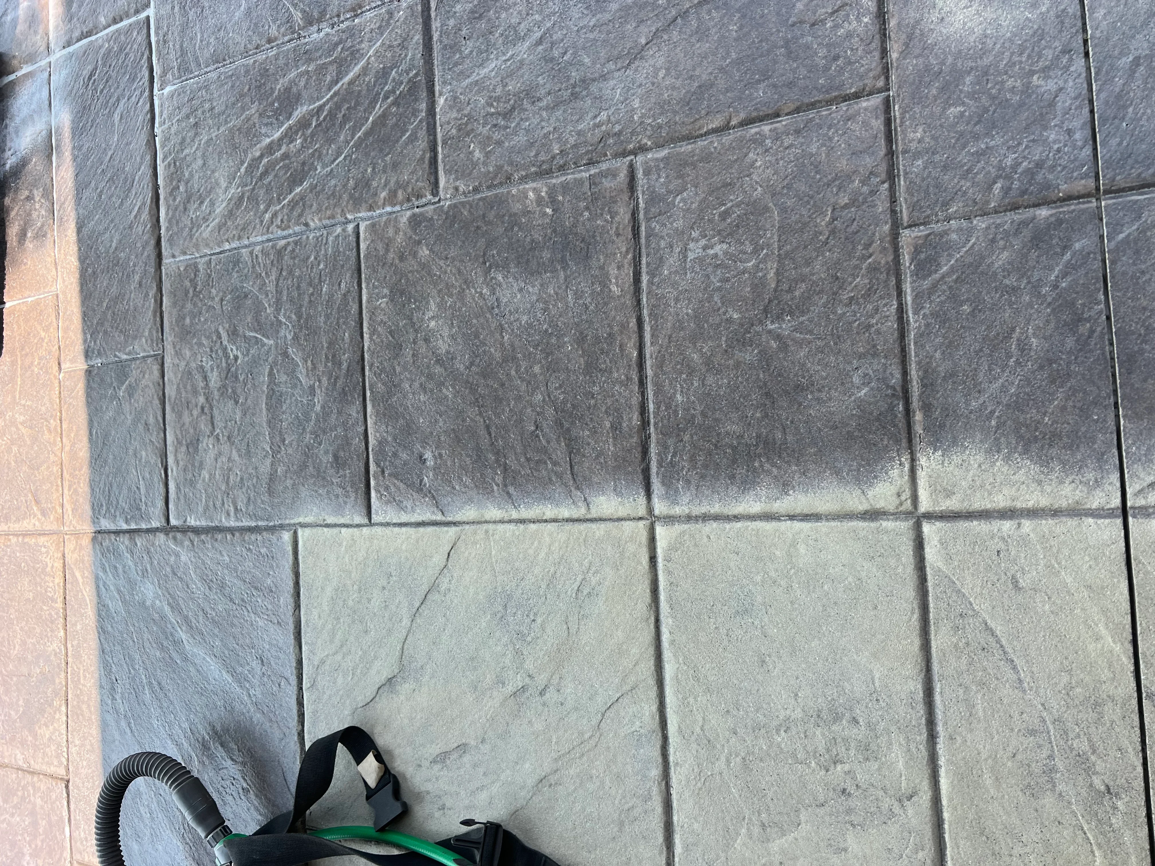 Sandblasted slate tiles in charcoal and cream tones with clean grout lines and textured finish